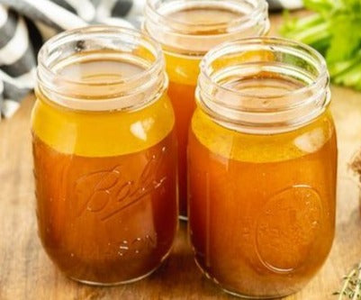 Beef broth in "ball" glass jars ready for canning.