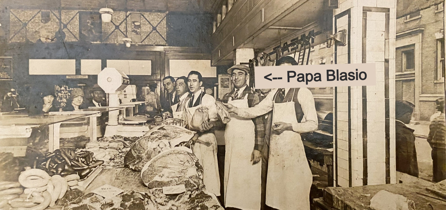 Group of butchers in a city butcher shop with one butcher called out as Papa Blasio