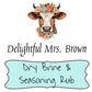 Logo for Delightful MRs. Brown Dry Brine & Seasoning Rub with a brown cow with small horns wearing a crown and necklace of various pastel colored daisies
