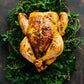 A beautifully roasted whole chicken on a bed of herbs ready to cut and eat providing inspiration for preparing a whole chicken